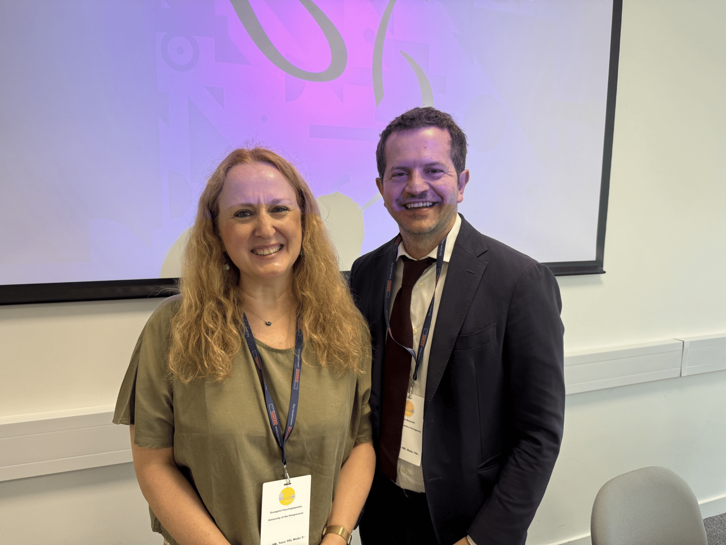 An image portraying two people during a conference